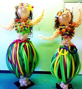 This pair of five foot tall balloon balloon sculpture hula dancers appear to be dancing with their colorful non-round balloon hula skirts
